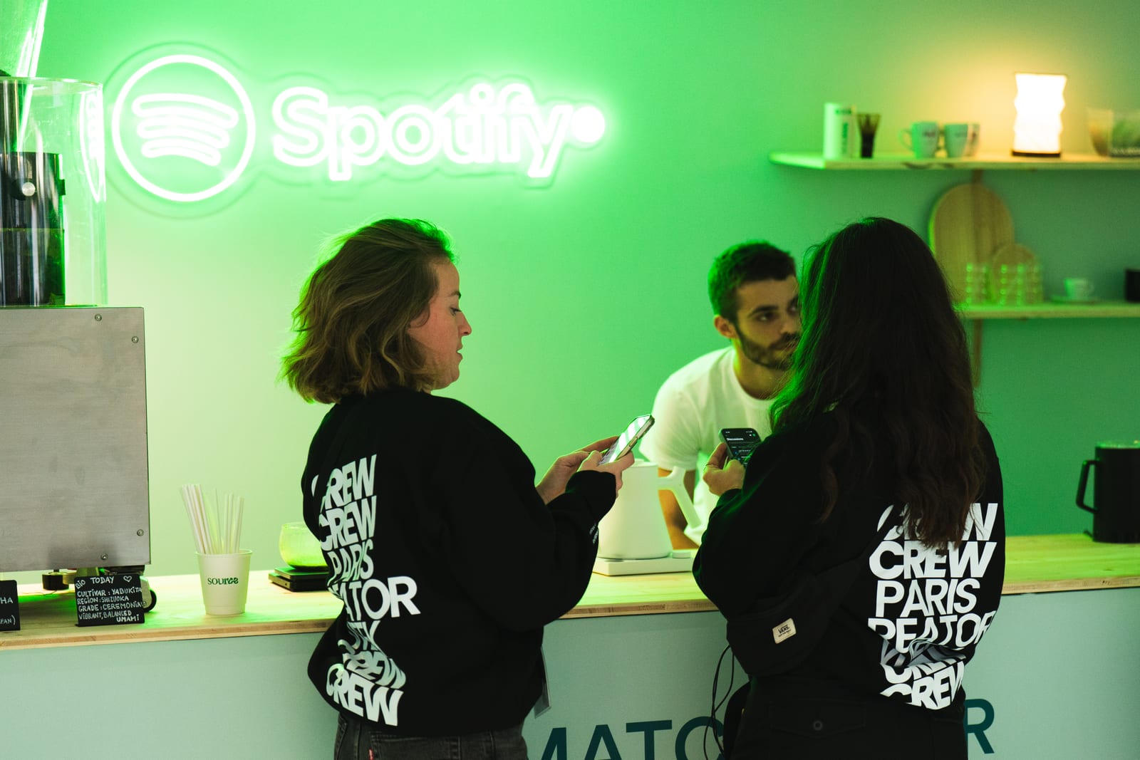 Attendees at the Spotify neon-lit stand